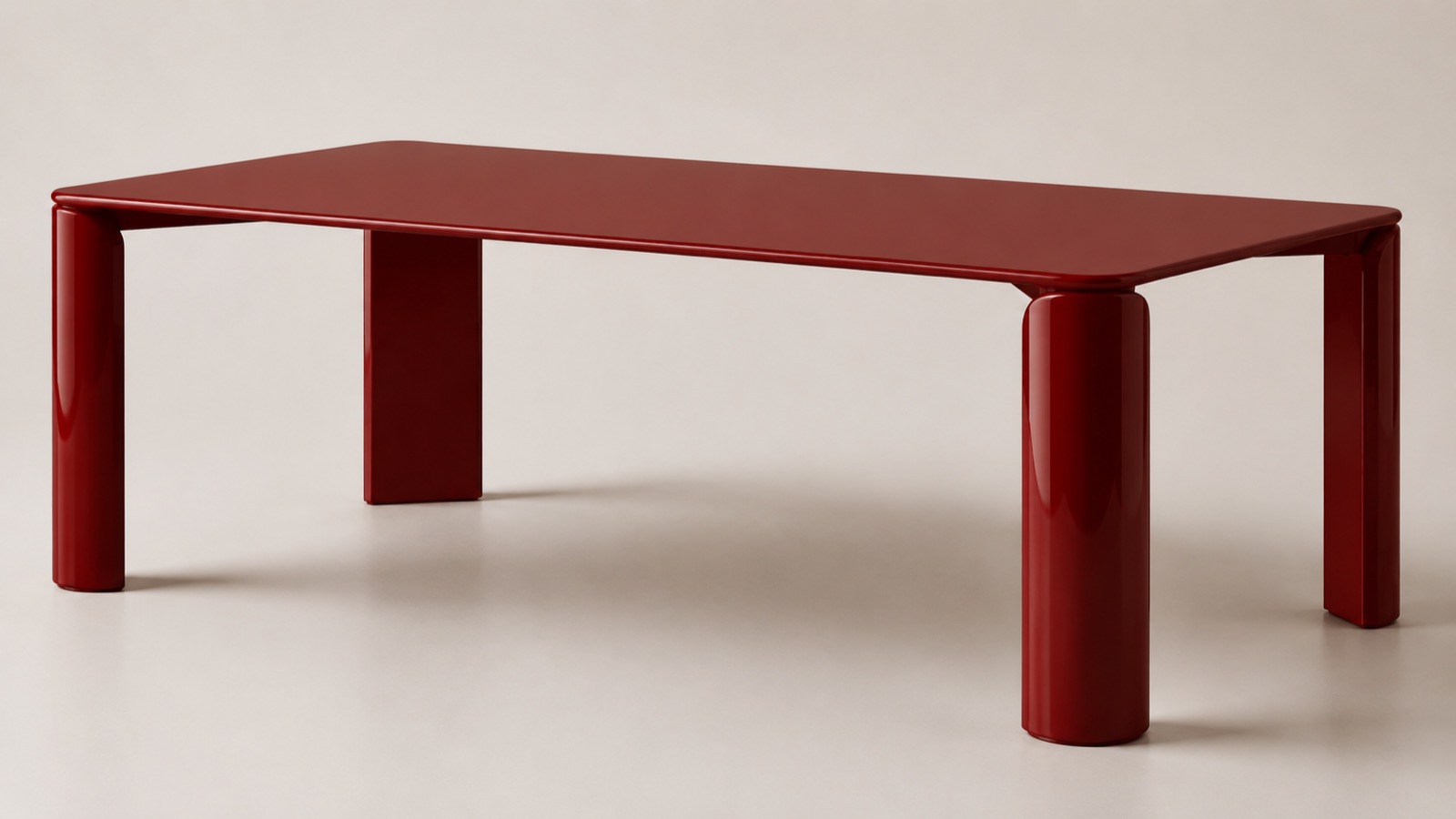 Monolite dining table in glossy oxide-red lacquer, two cylindrical legs and two flat legs